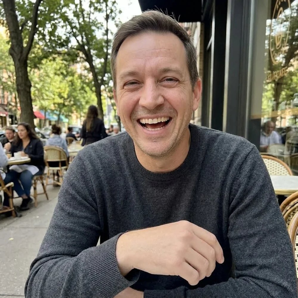 Man laughing at an outdoor café street